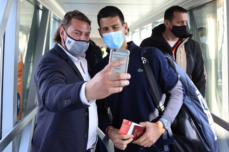 A man takes a selfie with Serbian tennis player Novak Djokovic as he arrives at Nikola Tesla Airport, after the Australian Federal Court upheld a government decision to cancel his visa to play in the Australian Open, in Belgrade, Serbia  January 17, 2022.  REUTERS / Christopher Pike