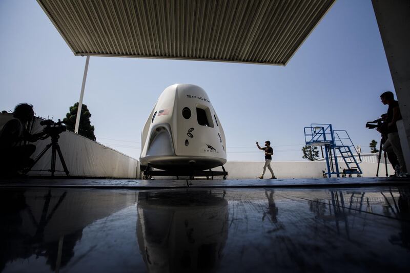 An attendee takes pictures of a mock up of the Crew Dragon spacecraft ahead of the NASA Commercial Crew Program astronaut visit at the SpaceX headquarters in Hawthorne, California. Patrick T Fallon/Bloomberg