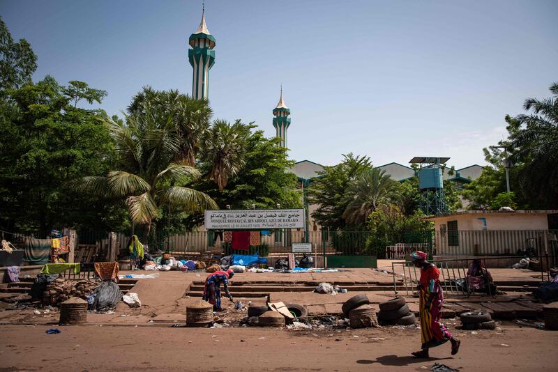 Women stand in front of The Grand Faycal Mosque in Bamako.