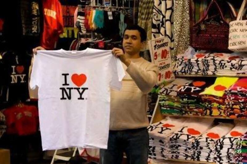 A street vendor on 7th Avenue near Broadway and Times Square holds up a "I Love New York" t-shirt. George Rose / Getty Images