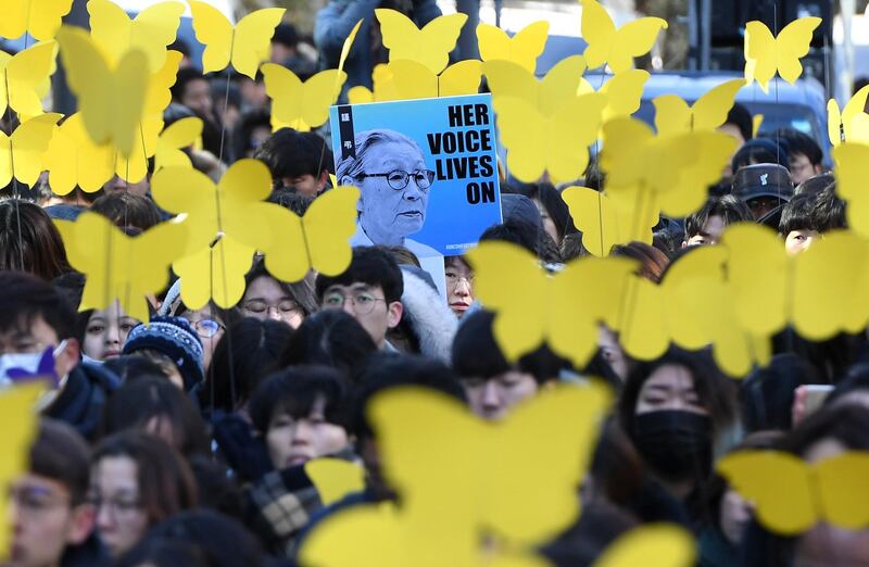 Mourners hold paper cutouts of yellow butterflies during a funeral ceremony of former South Korean "comfort woman" Kim Bok-dong in Seoul. AFP