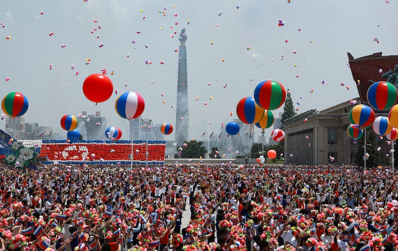 Celebratory balloons met Mr Putin during his welcoming ceremony. EPA / Sputnik