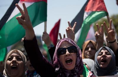 Palestinian women chant slogans and flash the victory sign as they demonstrate against Israeli plans for the annexation of parts of the West Bank, in Gaza City, Wednesday, July 1, 2020. (AP Photo/Khalil Hamra)