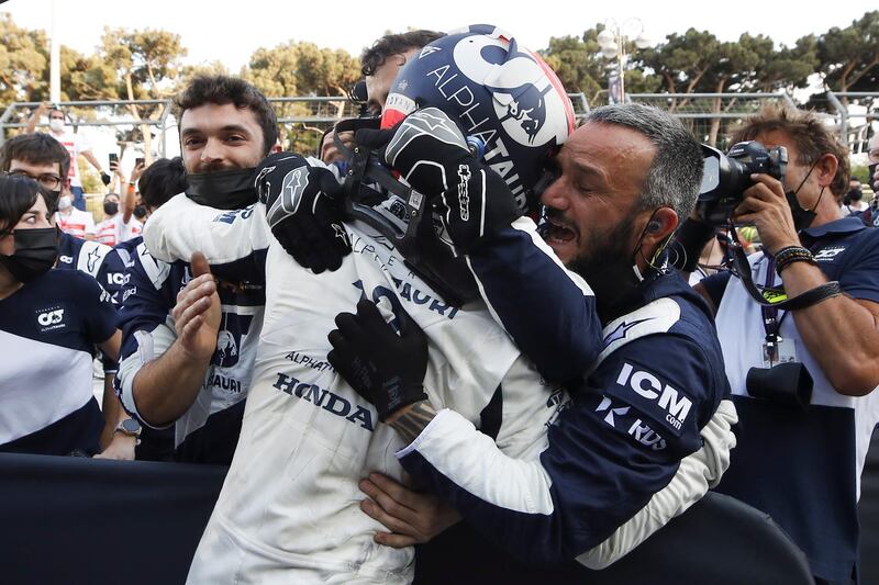 Pierre Gasly is mobbed by his Alpha Tauri team after finishing third. EPA