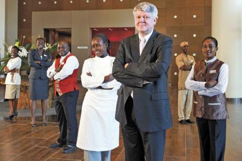 Staff at the Movenpick Ambassador Hotel Accra in Ghana, wearing uniforms designed by Emile Rassam