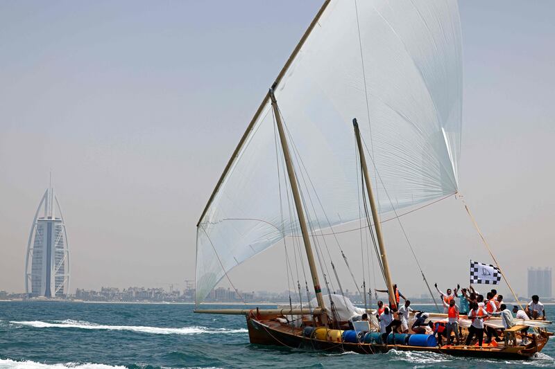 The Hasheem team celebrate after crossing the finish line of the annual long-distance dhow sailing race, known as Al Gaffal, near Sir Abu Nuair island towards Dubai. AFP