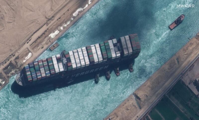 TOPSHOT - This satellite imagery released by Maxar Technologies shows a close up overview of the MV Ever Given container ship and tugboats in the Suez Canal on March 29, 2021. The MV Ever Given was refloated and the Suez Canal reopened on March 29, 2021, sparking relief almost a week after the huge container ship got stuck during a sandstorm and blocked a major artery for global trade. AFP correspondents observed tugboat crews sounding their foghorns in celebration after the Ever Given, a cargo megaship the length of four football fields, was dislodged from the banks of the Suez.

 - RESTRICTED TO EDITORIAL USE - MANDATORY CREDIT "AFP PHOTO / Satellite image ©2021 Maxar Technologies" - NO MARKETING - NO ADVERTISING CAMPAIGNS - DISTRIBUTED AS A SERVICE TO CLIENTS
 / AFP / Satellite image ©2021 Maxar Technologies / - / RESTRICTED TO EDITORIAL USE - MANDATORY CREDIT "AFP PHOTO / Satellite image ©2021 Maxar Technologies" - NO MARKETING - NO ADVERTISING CAMPAIGNS - DISTRIBUTED AS A SERVICE TO CLIENTS
