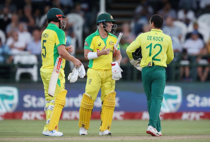 Cricket - South Africa v Australia - Third T20 - Newlands Cricket Ground, Cape Town, South Africa - February 26, 2020   Australia's David Warner and Aaron Finch speak with South Africa's Quinton de Kock during the match   REUTERS/Mike Hutchings