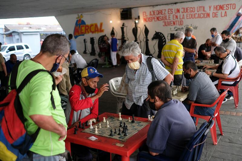 Men play chess under a bridge in Caracas, Venezuela. AP Photo