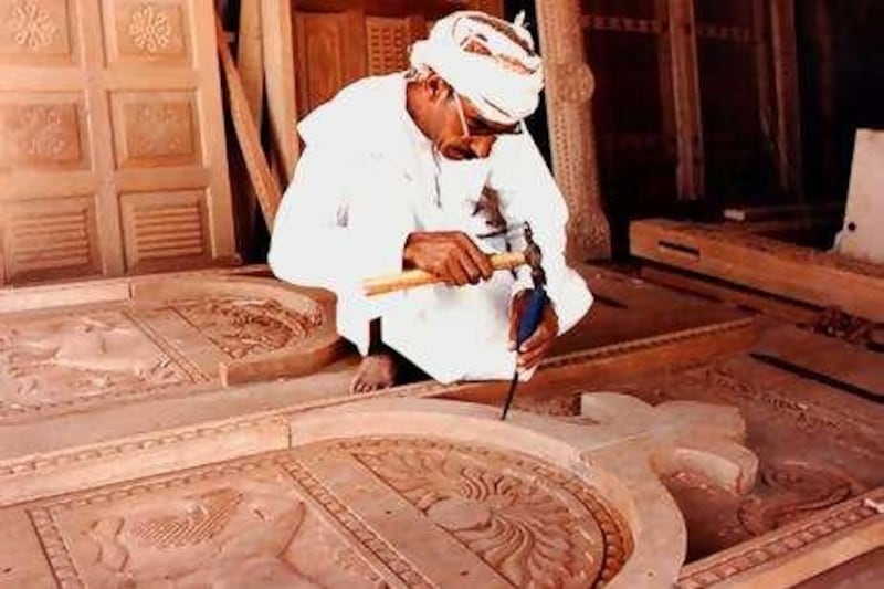 caption for this: Mr Hamdoon works in his wood carving workshop at Nizwa, Oman

 Saleh Al-Shaibany/The National?