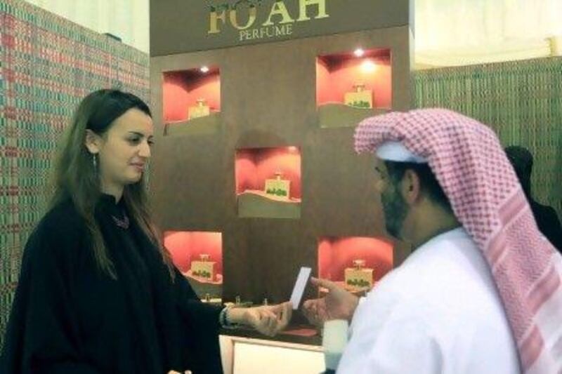 A visitor samples one of the Fo'ah date palm-based perfumes at the Liwa Date Festival last week.