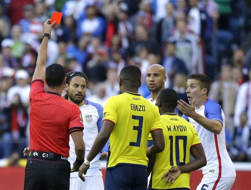Referee Wilmar Roldan, left, shows a red card to United States midfielder Jermaine Jones second from left, in the second half of a Copa America Centenario soccer match against Ecuador, Thursday, June 16, 2016 at CenturyLink Field in Seattle. The United States beat Ecuador 2-1. (AP Photo/Ted S. Warren)