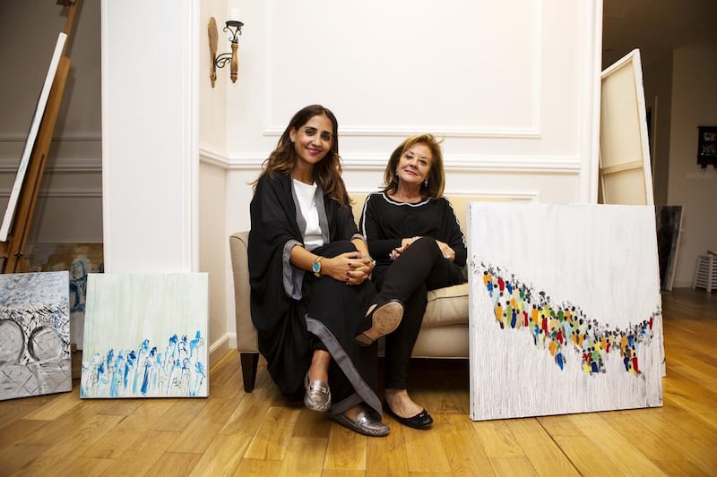 Artists Fatima Al Jaroudi, right, and her daughter Noura Ali Al Ramahi. Their paintings will be on display at the A Picture and 1,000 Words exhibition in Abu Dhabi from Saturday. Christopher Pike / The National