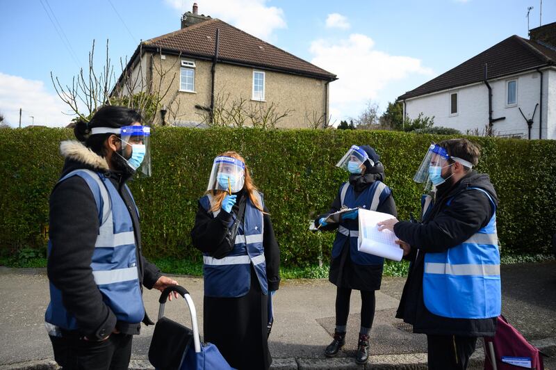 Volunteers plan where to head next as they deliver Covid-19 test kits to the doors of residents near Muswell Hill in London. Getty Images