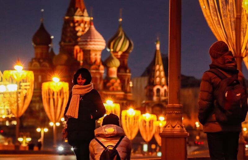 People take pictures of St. Basil's Cathedral, decorated for the upcoming Christmas and New Year's celebrations in Moscow, Russia. EPA