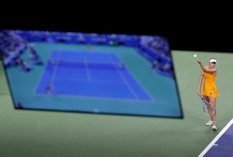 A television monitor displays court action as Sofia Kenin, of the United States, serves to Karolina Pliskova, of the Czech Republic, during the third round of the US Open tennis tournament. AP
