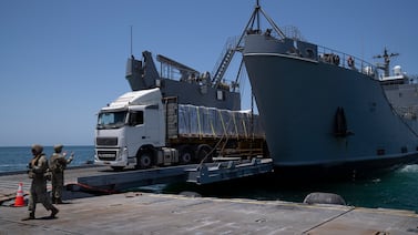 Lorries loaded with humanitarian aid arrive at the US-built floating pier off Gaza before reaching the beach on the coast of the Gaza Strip, on June 25, 2024. AP