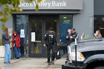 A Brinks worker after leaving Silicon Valley Bank in Santa Clara, California on Friday. The US rushed to seize the assets of SVB after a run on the bank. AP