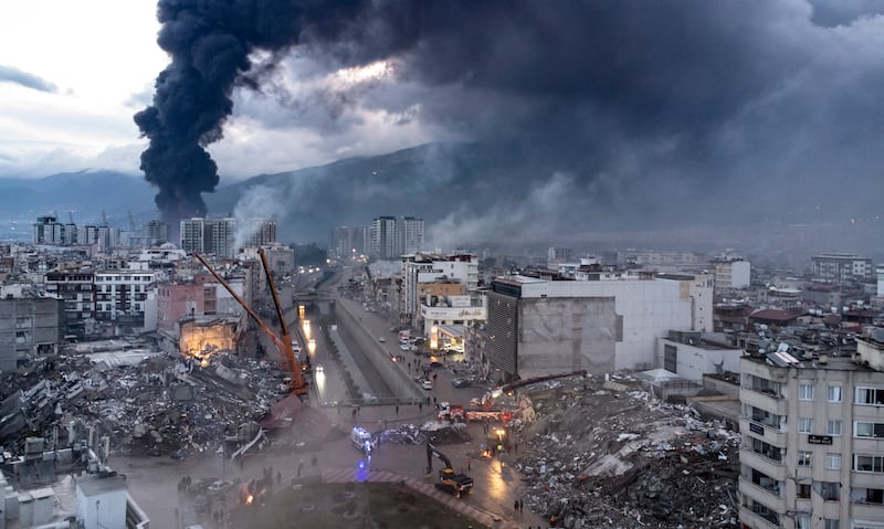 Smoke billows from the site of a collapsed building in Turkey. EPA
