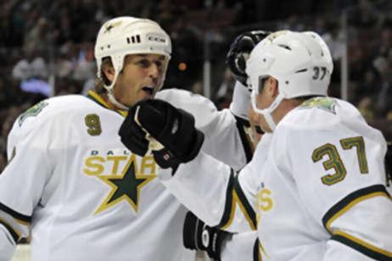 The Dallas Stars right wing Mark Parrish, right, is greeted by Mike Modano after scoring against the Anaheim Ducks.