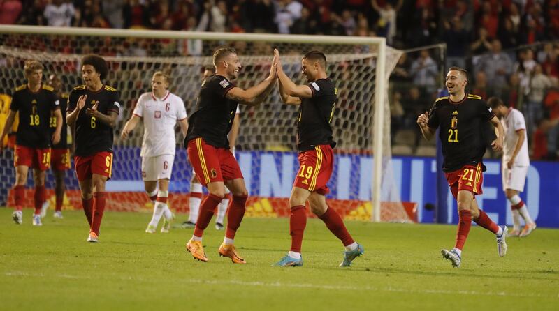 Leander Dendoncker and Toby Alderweireld celebrate Belgium's fifth gaol against Poland. EPA