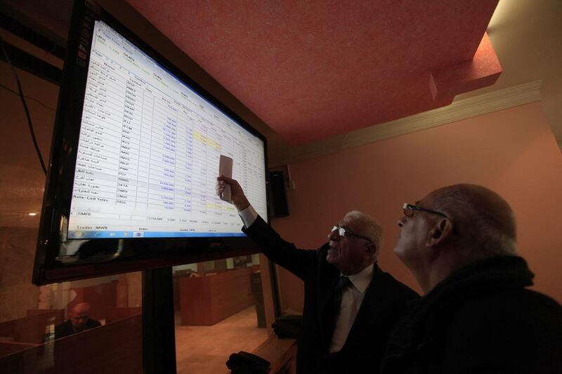 The Iraqi Stock Exchange has had its challenges – from a lack of liquidity to serious security concerns. Above, investors monitor stock prices at the bourse in Baghdad in February. Ahmed Saad / Reuters