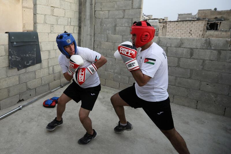 Jordanian brothers Hussein and Zeyad Ashish, boxers who qualified for the next Olympics, train on the roof of their home at Al Baqaa Palestinian refugee camp, near Amman. Reuters