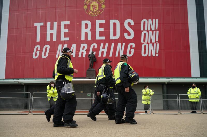 Police and security staff stand guard outside Old Trafford ahead of the Premier League match between Manchester United and Liverpool. Getty