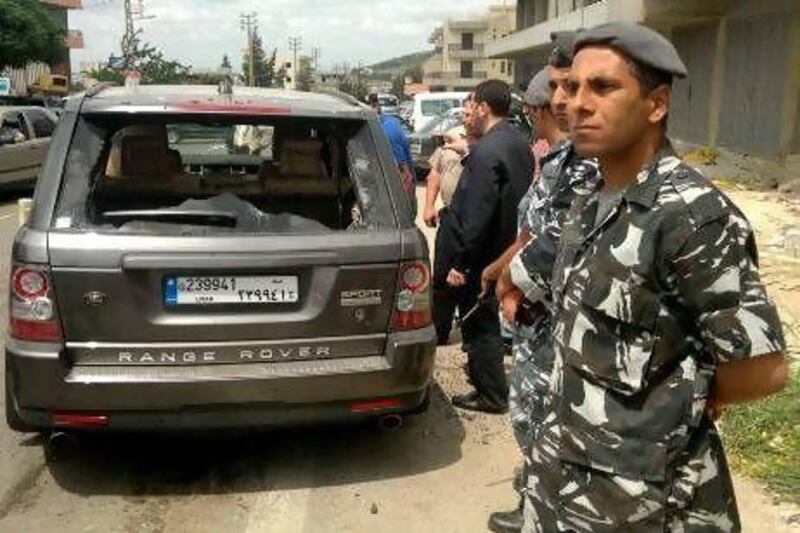 Lebanese security stands by the car in which the Sunni cleric, Sheikh Ahmed Abdul Wahid, and another member of a political alliance against the Syrian president, Bashar Al Assad, were shot dead yesterday by Lebanese soldiers, near Halba town in north Lebanon.