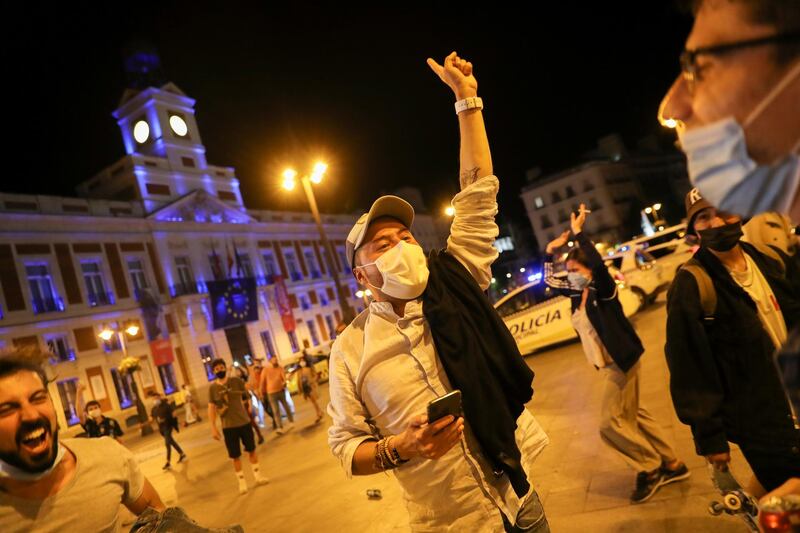 People celebrate the lifting of the state of emergency decreed by the Spanish Government to prevent the spread of Covid-19 at Puerta del Sol square in Madrid. Reuters
