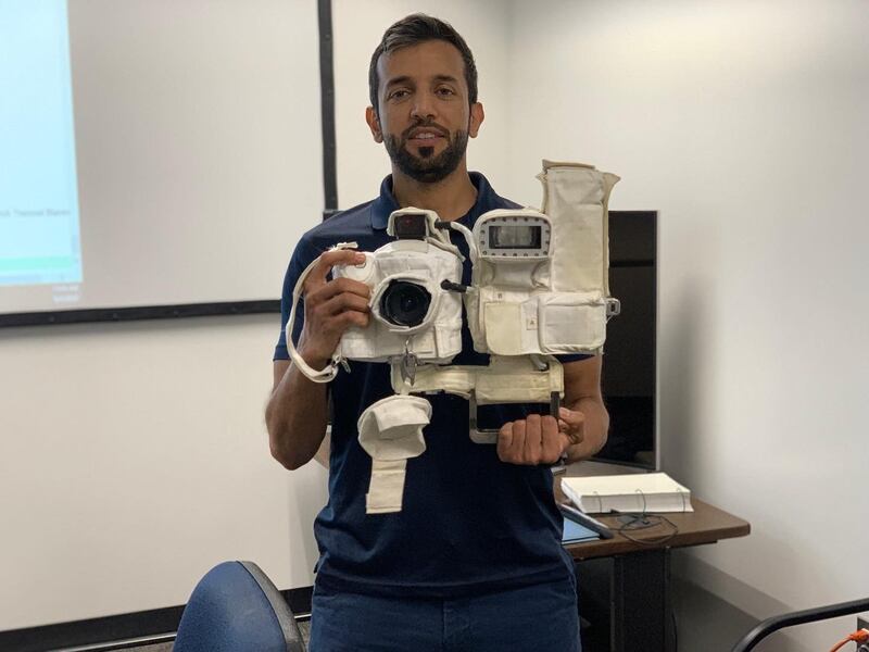 Dr Al Neyadi holding a camera that is used during spacewalks. He is the astronaut going on the next space mission.