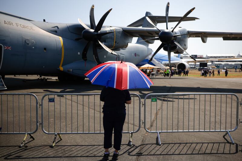 An aviation enthusiast shelters from the sun at the show. Temperatures were forecast to reach 40°C in parts of England. Bloomberg