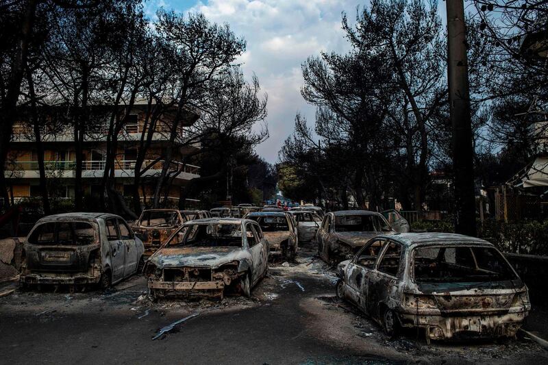 Cars burnt following a wildfire at the village of Mati. AFP