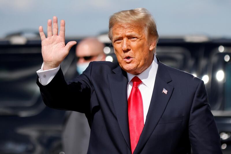 FILE PHOTO: U.S. President Donald Trump waves as he arrives at Palm Beach International Airport in West Palm Beach, Florida, U.S., January 20, 2021. REUTERS/Carlos Barria/File Photo