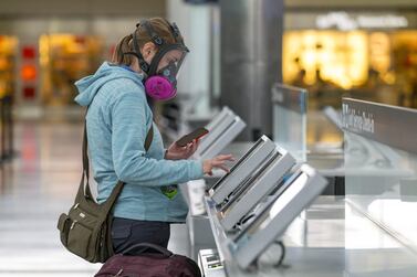 A traveller wearing a respirator uses an automated check-in kiosk at San Francisco International Airport in California. The aviation industry’s losses for this year and next will be five times those accumulated during the 2008-2009 recession, said Iata. Bloomberg