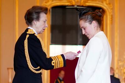 Princess Anne, left, presents rugby union referee Sara Cox with her MBE at Windsor Castle. AP