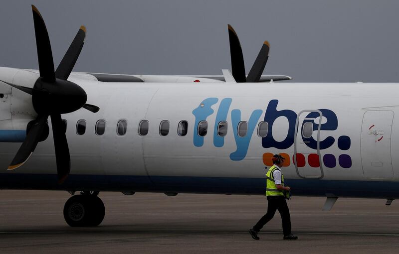 FILE PHOTO: An airport worker examines a flybe aircraft before it takes off from Liverpool John Lennon Airport in Liverpool northern England, May 19 , 2016. REUTERS/Phil Noble/File Photo