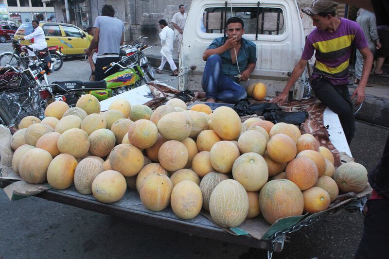 A street vendor sells melons during Ramadan in Raqqa under ISIS occupation in July 2014.