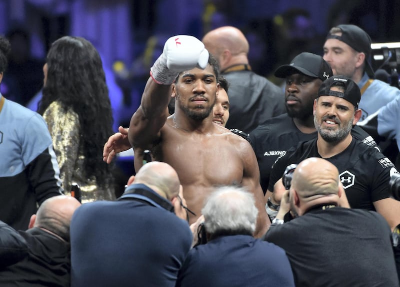 British boxer Anthony Joshua celebrates after winning the heavyweight boxing match between Andy Ruiz Jr. and Anthony Joshua for the IBF, WBA, WBO and IBO titles in Diriya, near the Saudi capital on December 7, 2019. - Ruiz seeks to win back the titles that he lost to Ruiz in a shock June defeat in New York in this high-profile duel , dubbed "Clash on the Dunes". (Photo by Fayez Nureldine / AFP)