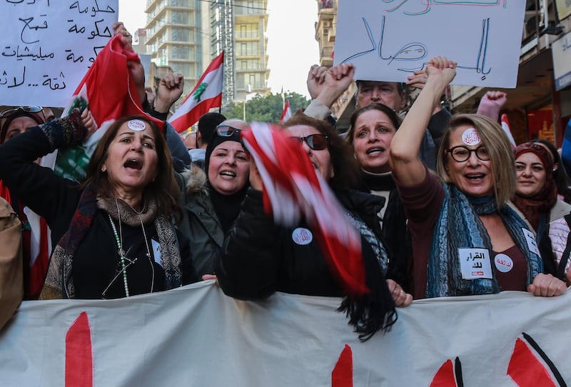 Anti-government protesters shout slogans as they hold up placards with slogans such as 'No Trust' in central Beirut, Lebanon. EPA