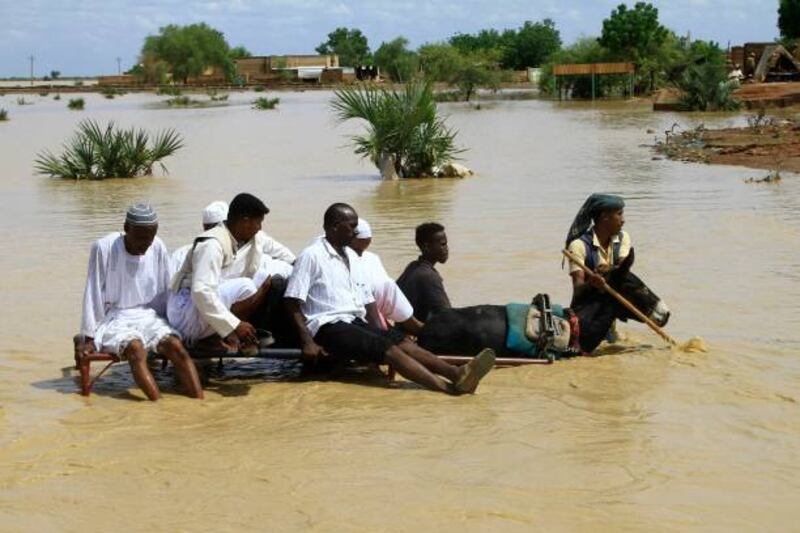 Sudanese cross a flooded road in the town of Iboud, 250 kilometres south of the capital Khartoum. AFP