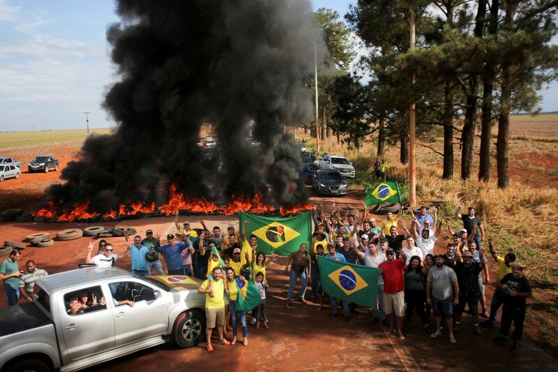 Supporters of Brazil's President Jair Bolsonaro block highway BR-251 during a protest against President-elect Luiz Inacio Lula da Silva who won a third term following the presidential election run-off, in Planaltina, Brazil. Reuters