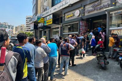People queue to buy bread outside a bakery in a suburb outside Beirut, Lebanon. EPA