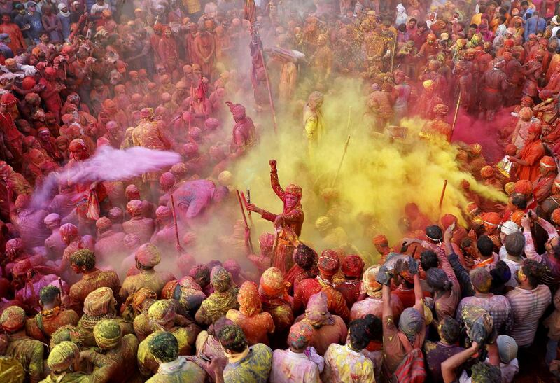 Men throw coloured powder at each other during Lathmar Holi celebrations, held despite the spread of the coronavirus, in the town of Nandgaon, in the northern state of Uttar Pradesh, India. Reuters