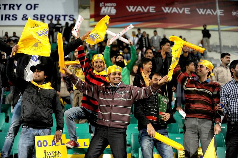 Indian spectators cheer during the Hero Hockey India League match played between the Delhi Waverider's and Punjab Warrior's in New Delhi. SAJJAD HUSSAIN / AFP