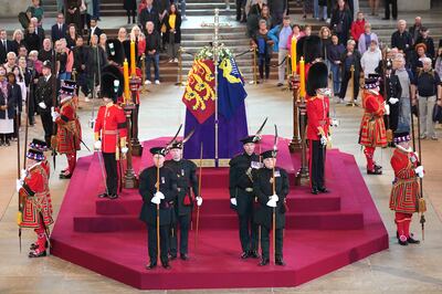 Members of the Royal Company of Archers guard the coffin of Queen Elizabeth lying in state in Westminster Hall. PA