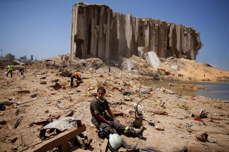 A rescue team worker rests at the site of a massive explosion in the port of Beirut, Lebanon. AP Photo