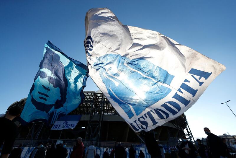 People wave Diego Maradona flags outside the Stadio San Paolo in Naples. Reuters