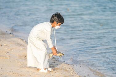 ABU DHABI, UNITED ARAB EMIRATES - June 14, 2021: HH Sheikh Hamdan bin Mohamed bin Hamdan Al Nahyan, participates in a turtle release with the The Environment Agency - Abu Dhabi. (Abdullah Al Junaibi for the Ministry of Presidential Affairs )​ ---