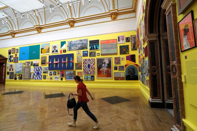A member of the Royal Academy of Arts staff walks into one of the galleries displaying artworks of 250th Summer Exhibition. Peter Nicholls / Reuters